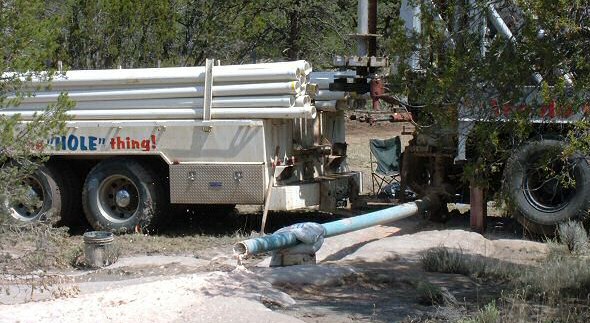 Photo of a well drilling rig in action